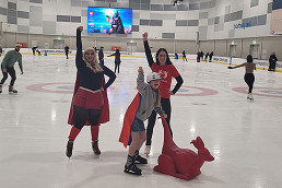 Superheroes skate for an event with heart